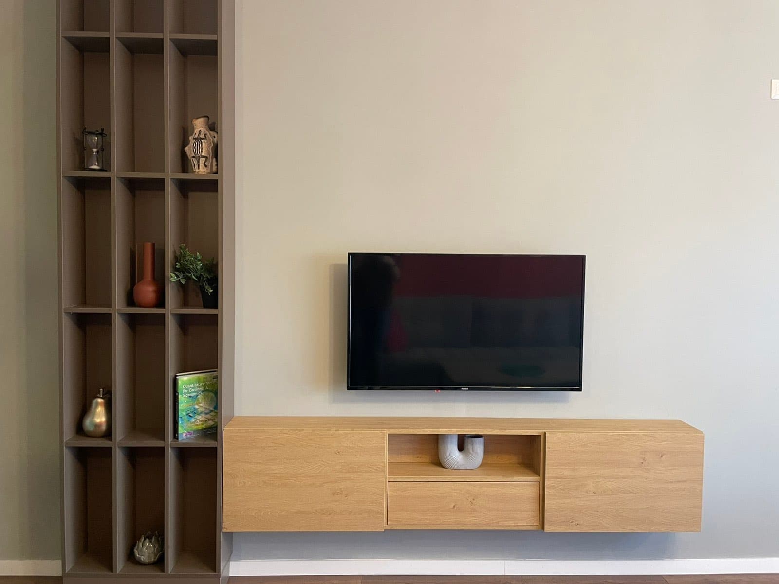 Wood media unit and open shelving on the living room wall